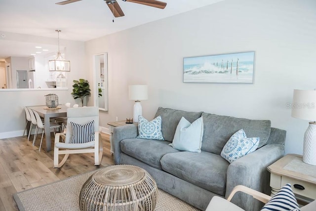 living room with ceiling fan and light hardwood / wood-style floors