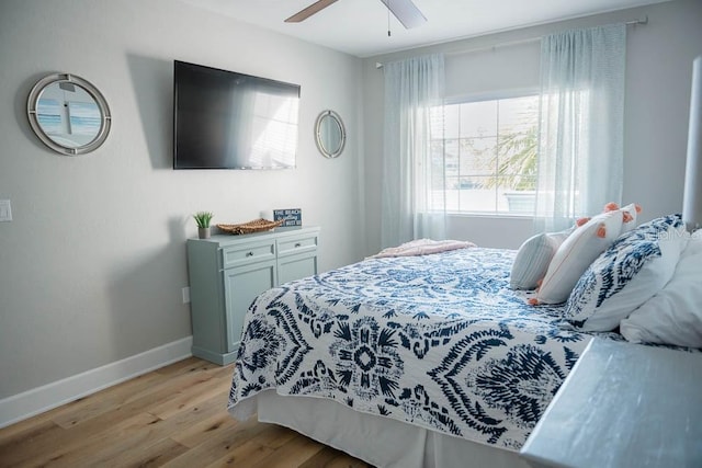 bedroom with light hardwood / wood-style floors and ceiling fan