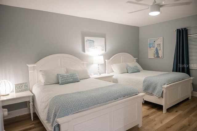 bedroom with ceiling fan and hardwood / wood-style floors