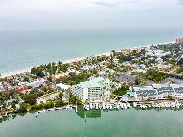 bird's eye view featuring a water view and a beach view