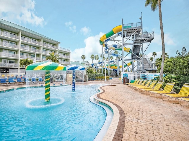 view of swimming pool featuring pool water feature and a water slide