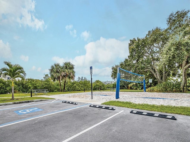 view of car parking with volleyball court