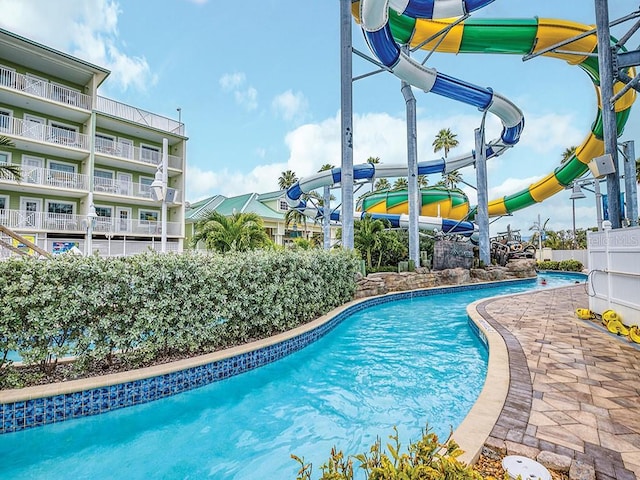 view of pool with a water slide