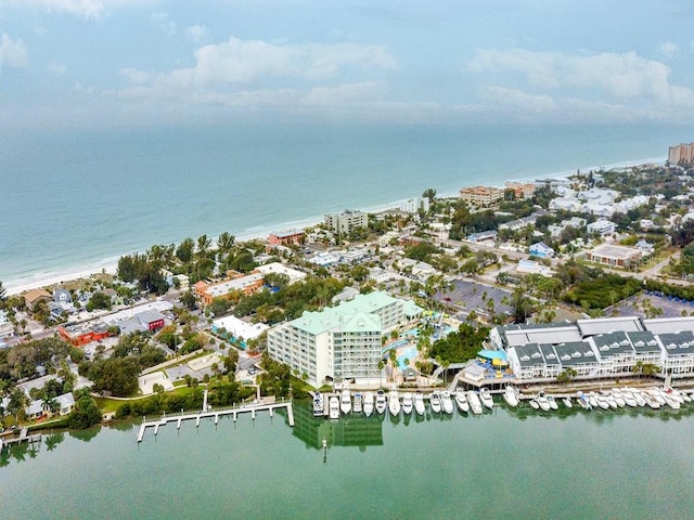 birds eye view of property featuring a water view and a beach view