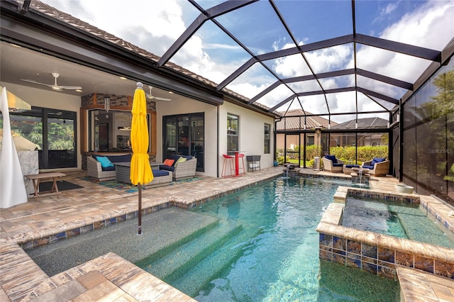 view of swimming pool with glass enclosure, ceiling fan, outdoor lounge area, an in ground hot tub, and a patio