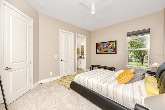 bedroom featuring light tile patterned floors, ceiling fan, and ensuite bathroom