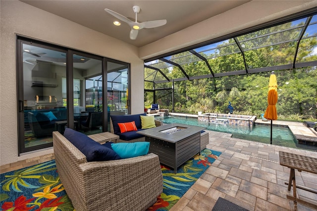 view of patio / terrace with a lanai, pool water feature, ceiling fan, and a pool with hot tub