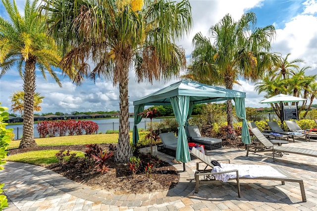 view of patio featuring a water view and a gazebo