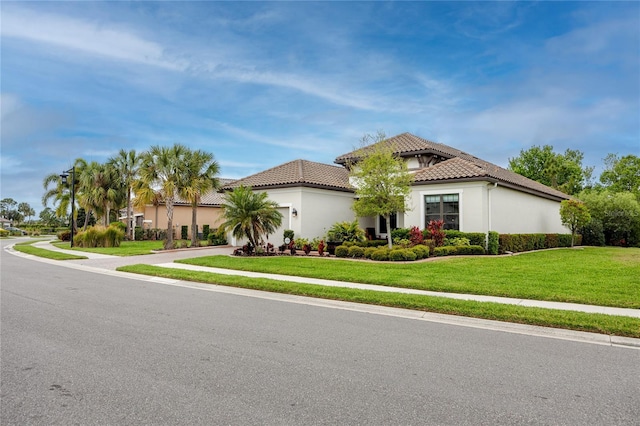 mediterranean / spanish-style house featuring a front lawn