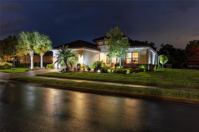 mediterranean / spanish-style home featuring a yard