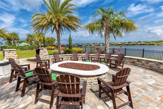 view of patio with a water view and a fire pit