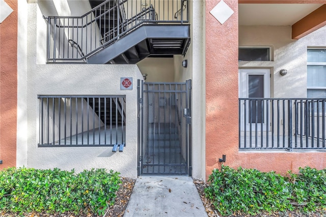 view of exterior entry with a balcony