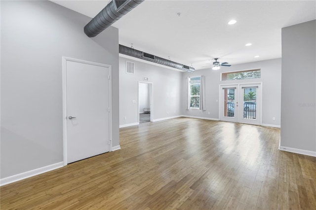 unfurnished living room featuring ceiling fan and light hardwood / wood-style flooring