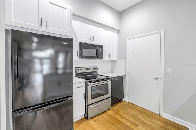 kitchen with white cabinets, light wood-type flooring, and black appliances