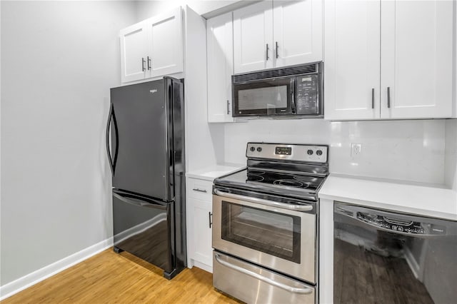 kitchen featuring light hardwood / wood-style flooring, white cabinets, and black appliances