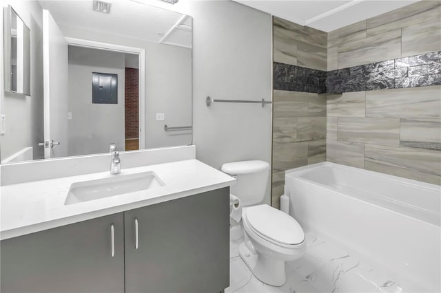 full bathroom with tiled shower / bath combo, toilet, tile floors, and vanity with extensive cabinet space