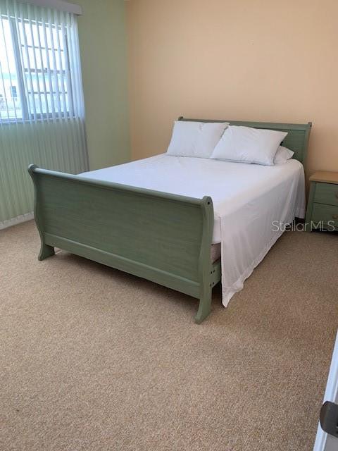 bedroom featuring light carpet