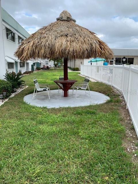 view of home's community featuring a lawn and a patio