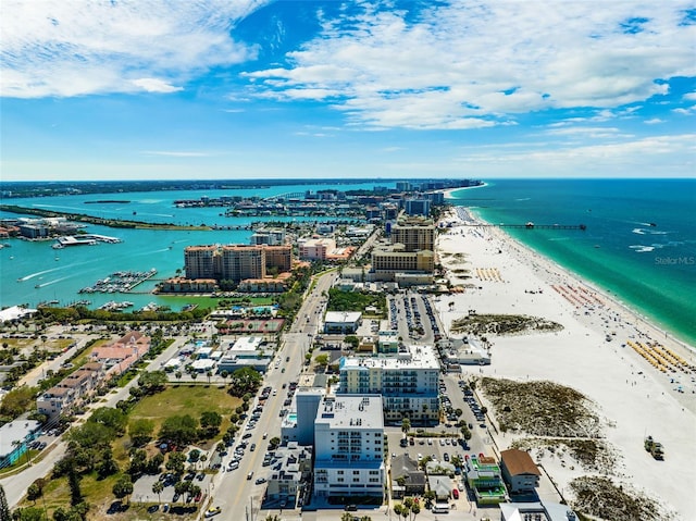 drone / aerial view with a water view and a beach view