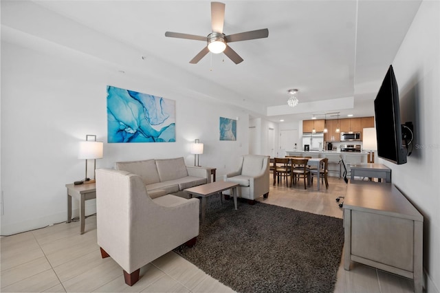 living room featuring ceiling fan and light tile patterned flooring