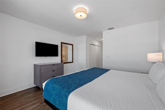 bedroom featuring dark hardwood / wood-style flooring and a closet