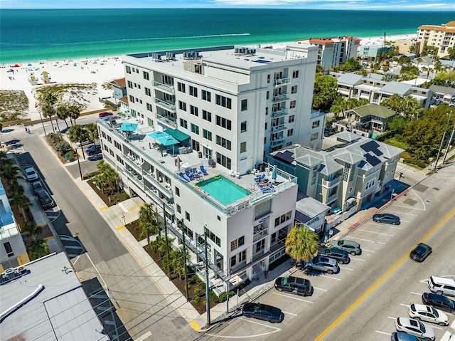 aerial view with a water view and a beach view