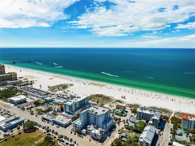 birds eye view of property featuring a water view and a beach view