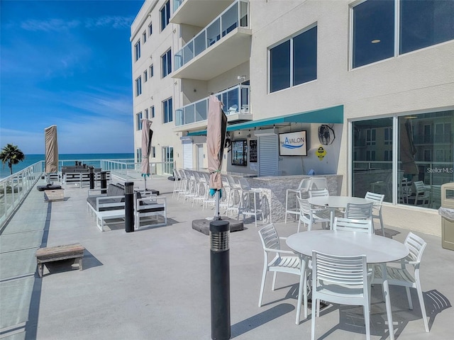 view of patio / terrace featuring a balcony and a water view