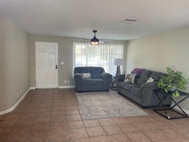 tiled living room featuring ceiling fan