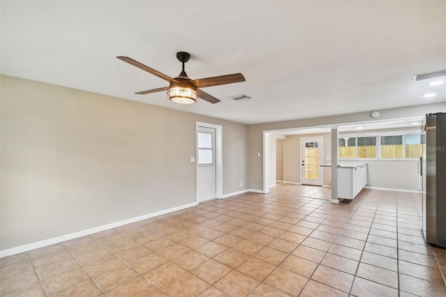 unfurnished living room with ceiling fan and light tile patterned floors