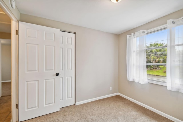 unfurnished bedroom featuring a closet and carpet floors