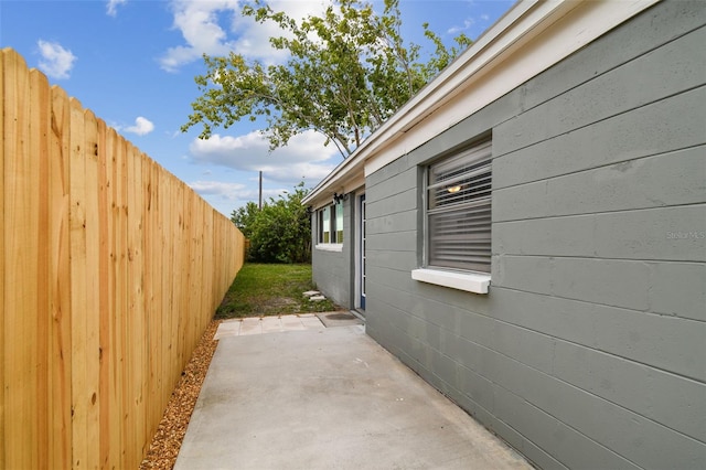 view of side of home with a patio area