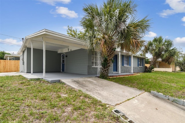 ranch-style house with a carport and a front yard