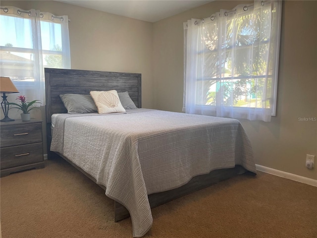 carpeted bedroom featuring multiple windows