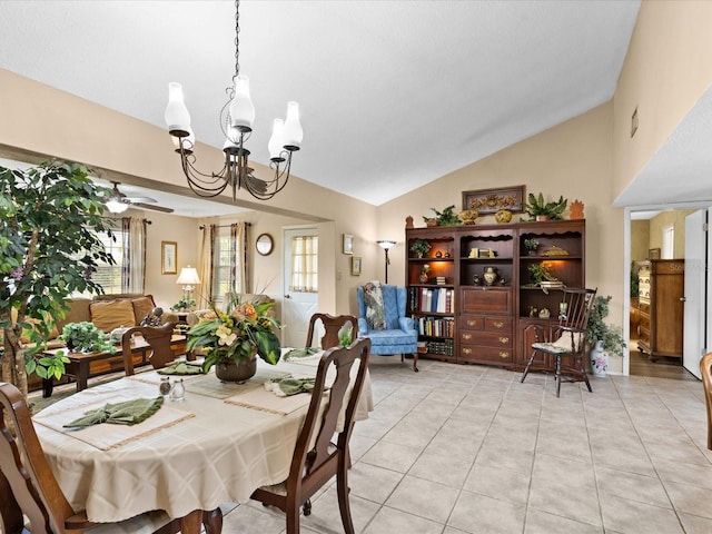 tiled dining room featuring vaulted ceiling and ceiling fan with notable chandelier