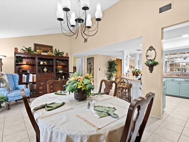 dining space with high vaulted ceiling, light tile flooring, and a chandelier