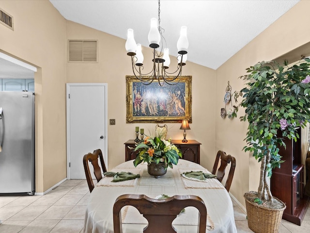 tiled dining area with an inviting chandelier and lofted ceiling