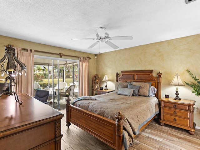 bedroom featuring light hardwood / wood-style flooring, ceiling fan, access to outside, and a textured ceiling