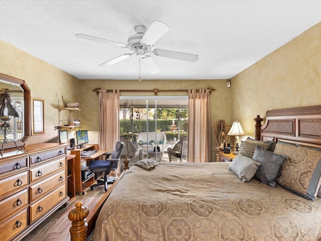 bedroom with a textured ceiling, access to outside, ceiling fan, and dark hardwood / wood-style floors