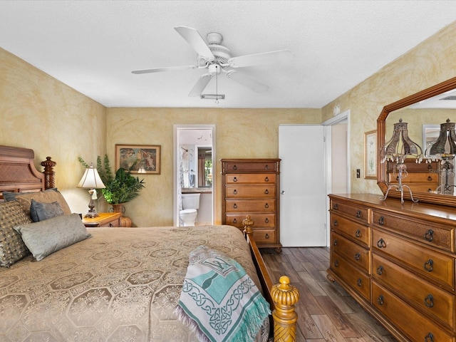 bedroom featuring dark hardwood / wood-style floors, ceiling fan, and ensuite bathroom