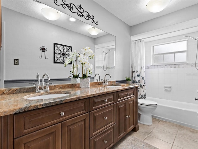 full bathroom featuring toilet, large vanity, double sink, tile flooring, and shower / tub combo with curtain