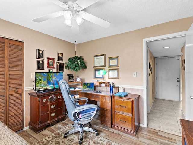 office with light tile flooring, ceiling fan, and a textured ceiling