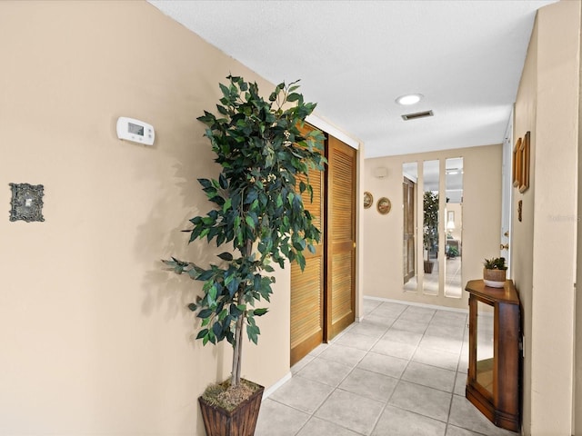 hallway with light tile floors