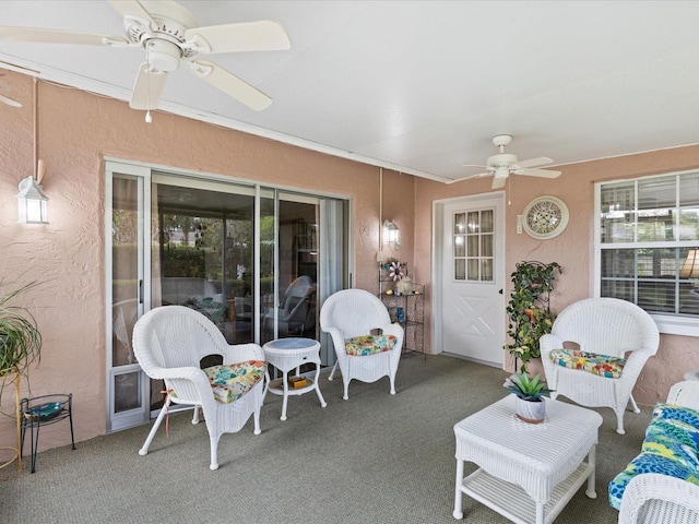 sunroom / solarium featuring ceiling fan