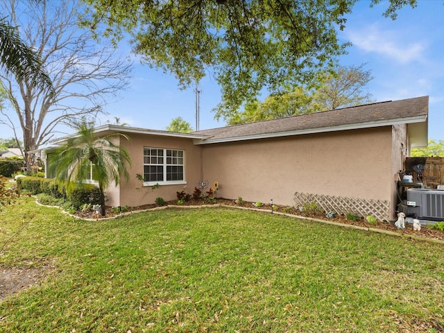 ranch-style house featuring a front yard and central AC