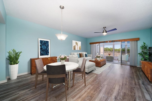 dining area featuring ceiling fan, dark hardwood / wood-style floors, and a textured ceiling