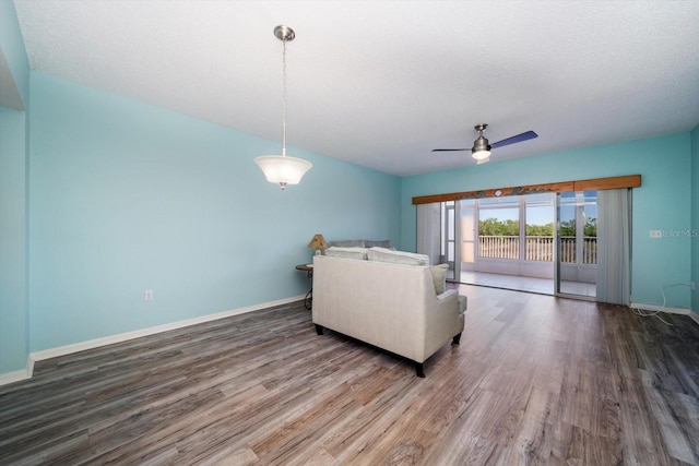 unfurnished living room featuring ceiling fan, a textured ceiling, and hardwood / wood-style flooring