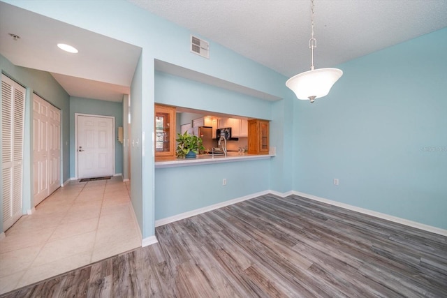 tiled spare room featuring a textured ceiling