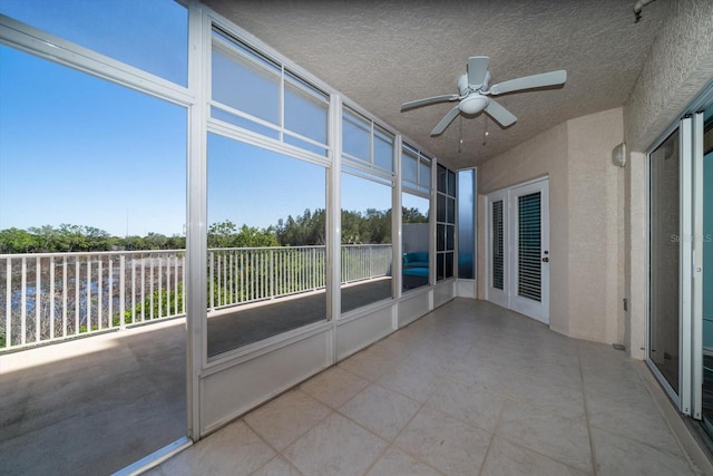 unfurnished sunroom with ceiling fan and a healthy amount of sunlight