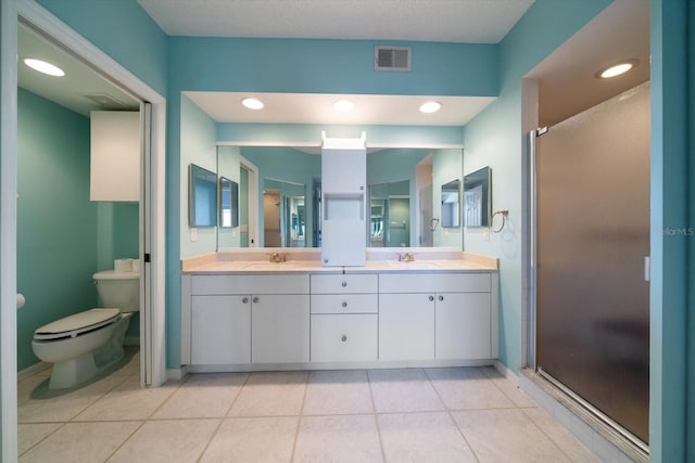 bathroom with toilet, double sink, vanity with extensive cabinet space, walk in shower, and tile flooring